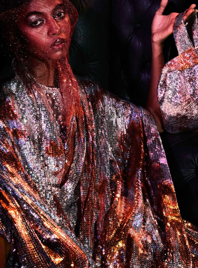 Silver sequin sheeted sari with texture printing on sequin in Orange